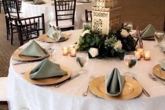 Gold Lanterns, Gold Chargers, White Linens, and Sage Napkins